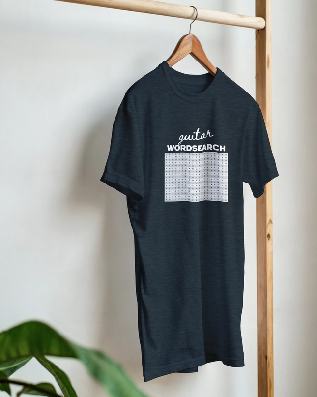 Flat-lay of Wordsearch tee paired with guitar and sheet music