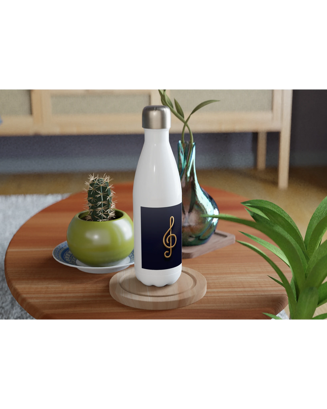 Flat-lay of bottle alongside headphones and a piano keyboard