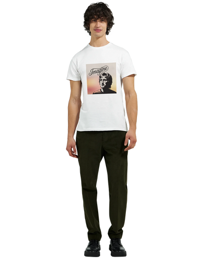 Studio shot of the Imagine T‑Shirt with soft lighting and music notes props”