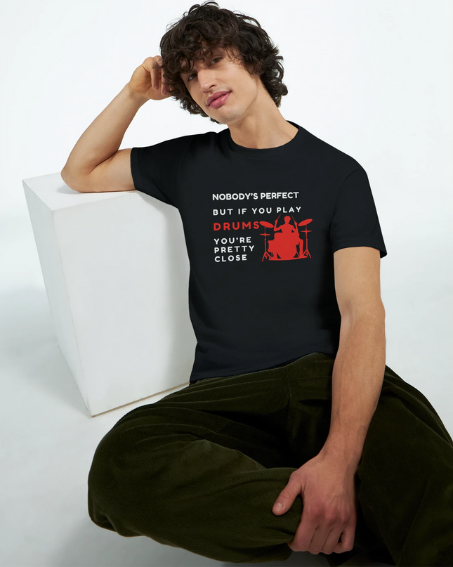 Lifestyle shot: tee draped over drum throne with kit in background