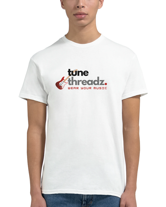 Flat-lay of music-themed T‑shirt with vinyl and notebook props