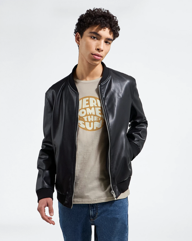 Close-up of sunburst design and lyric text on soft T‑shirt