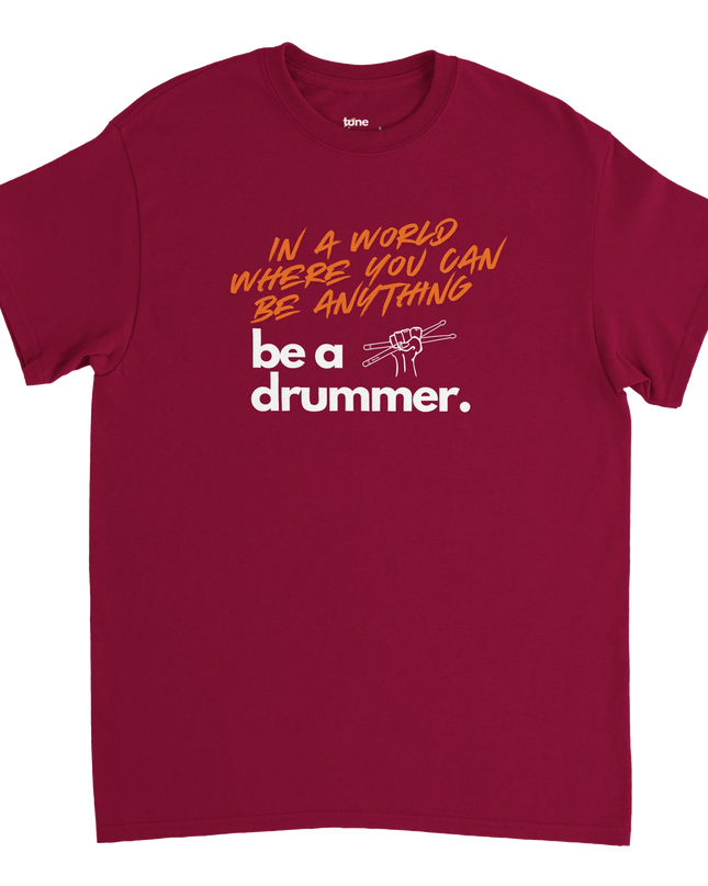 Overhead flat-lay of folded T-shirt next to a snare drum and headphones
