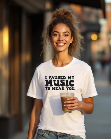 Flat-lay of shirt with concert ticket, earbuds, and handwritten lyrics
