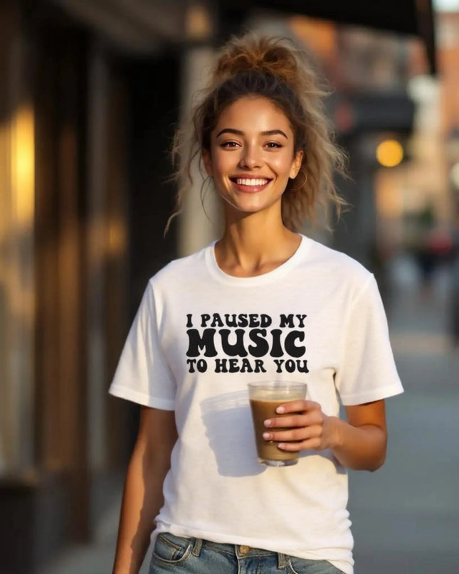 Flat-lay of shirt with concert ticket, earbuds, and handwritten lyrics