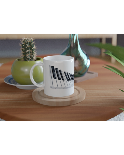 Hand holding the mug next to a piano performance space