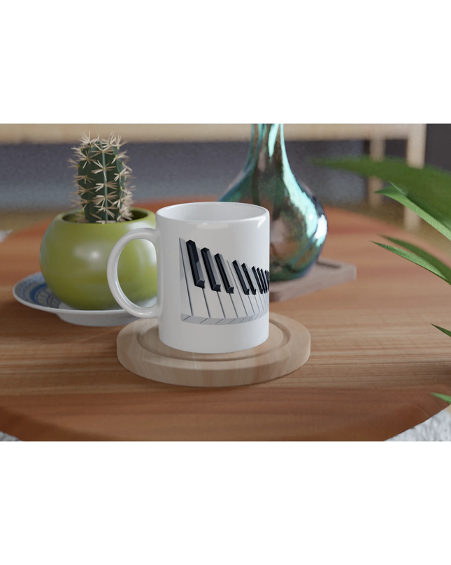 Hand holding the mug next to a piano performance space